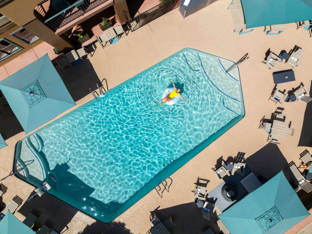Woman lounging in a floatie in Mountain Modern Sedona's heated outdoor pool